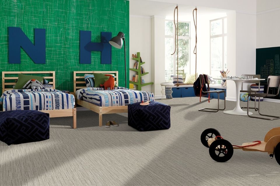bright kids' bedroom with green walls and beige soft carpet